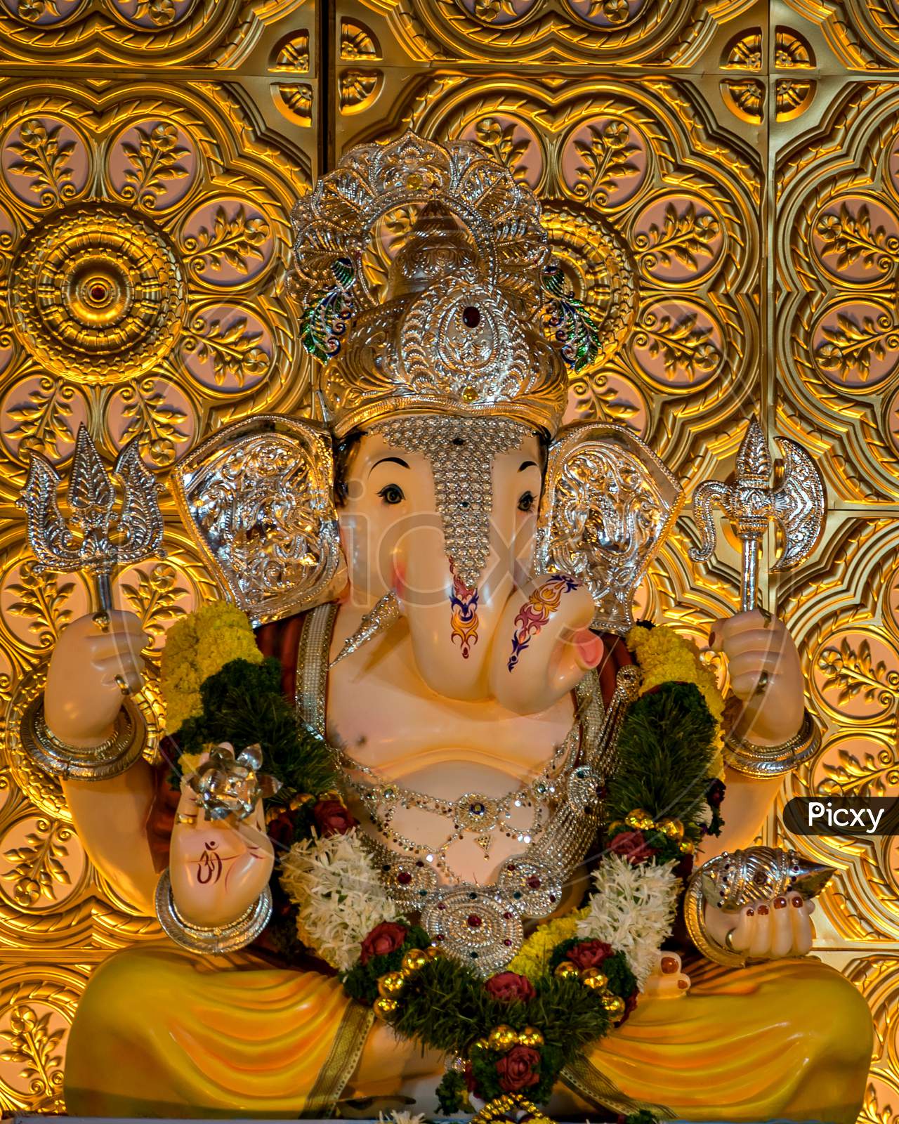 Closeup View Of Decorated And Garlanded Isolated Idol Of Hindu God Ganesha.
