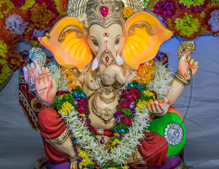 Portrait , Closeup View Of Decorated And Garlanded Idol Of Hindu God Ganesha.