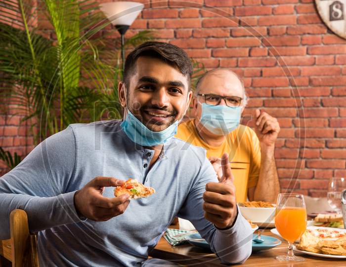 Indian family in restaurant after corona pandemic in unlock phase