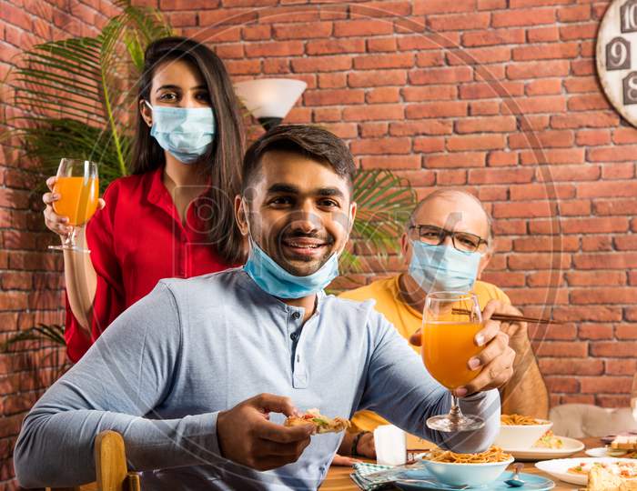 Indian family in restaurant after corona pandemic in unlock phase