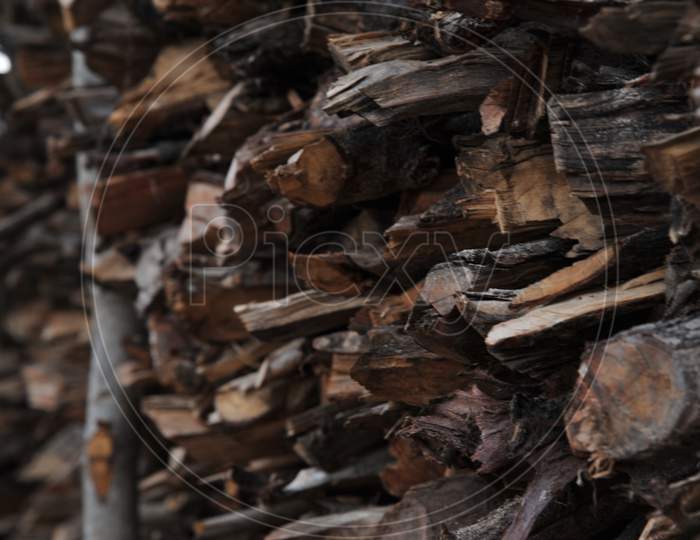 Wood logs stacked by pile closeup