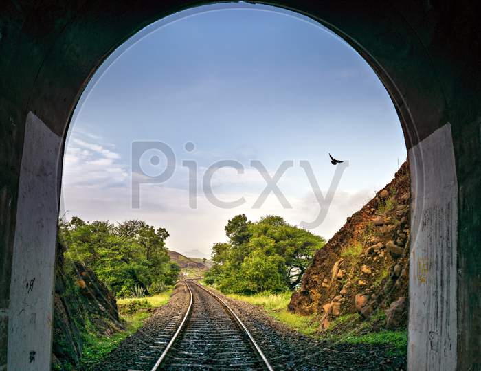 Image Of A Bird Through A Arched Railway Tunnel With Track.
