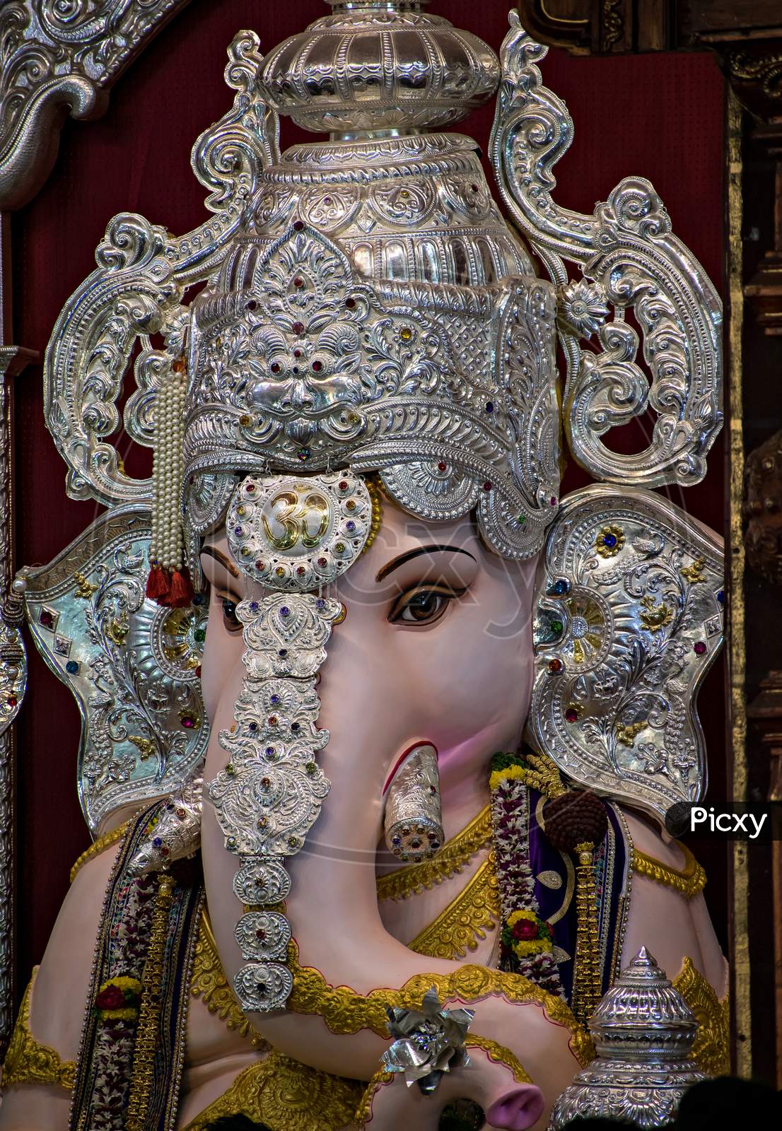 Close Up Portrait View Of Decorated And Garlanded Idol Of Hindu God Ganesha.