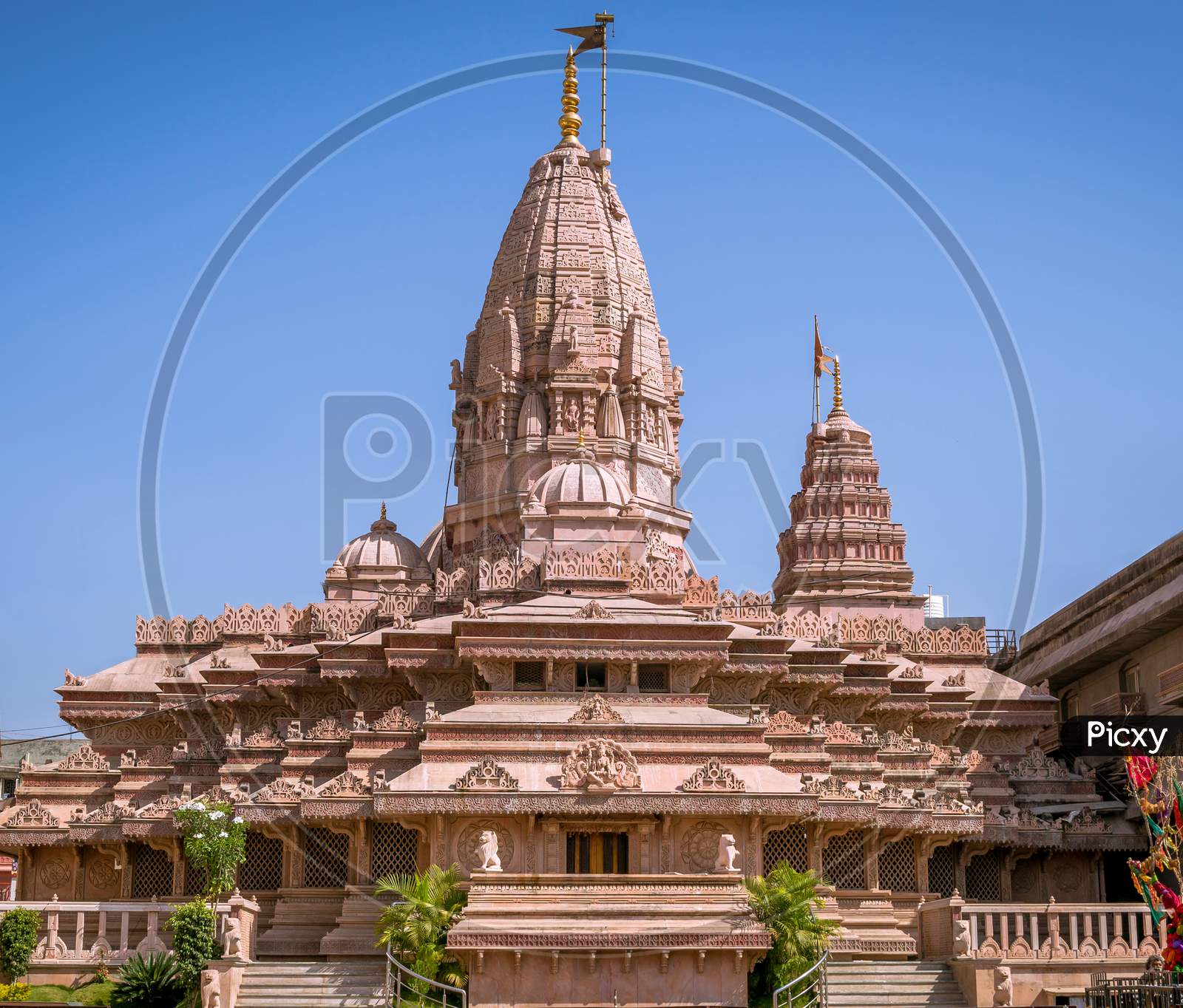 Nice Carvings On Goddess Ekveera Temple With Flag On Clear Blue Sky Background. Can Be Used As Wallpaper Background.