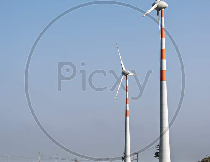 Windmills For Electricity Generation Near A Highway In Dwarka, Gujrat, India.
