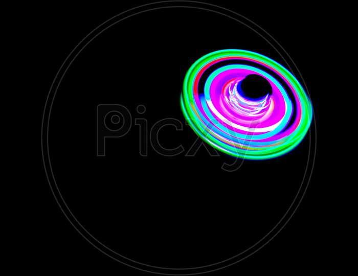 Long Exposure Photograph Of A Light Spinning Top With Black Background.