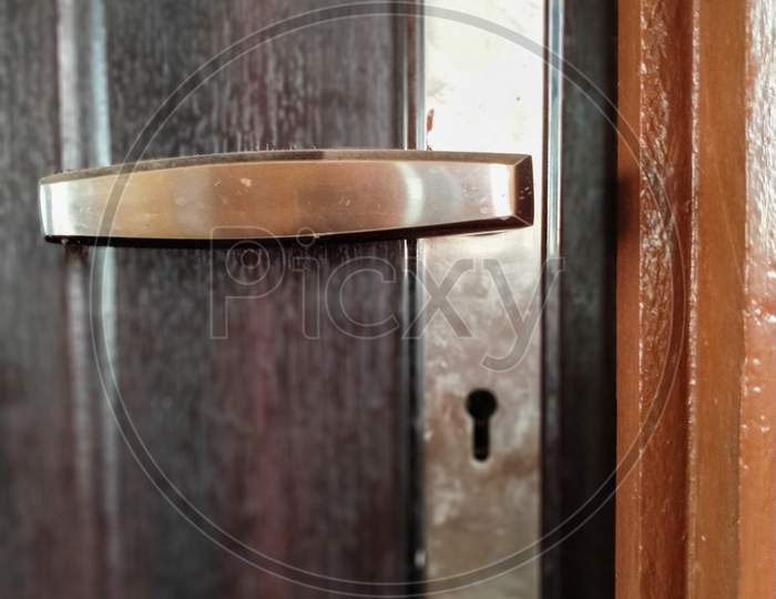 Golden Door Handle In A Wooden Door