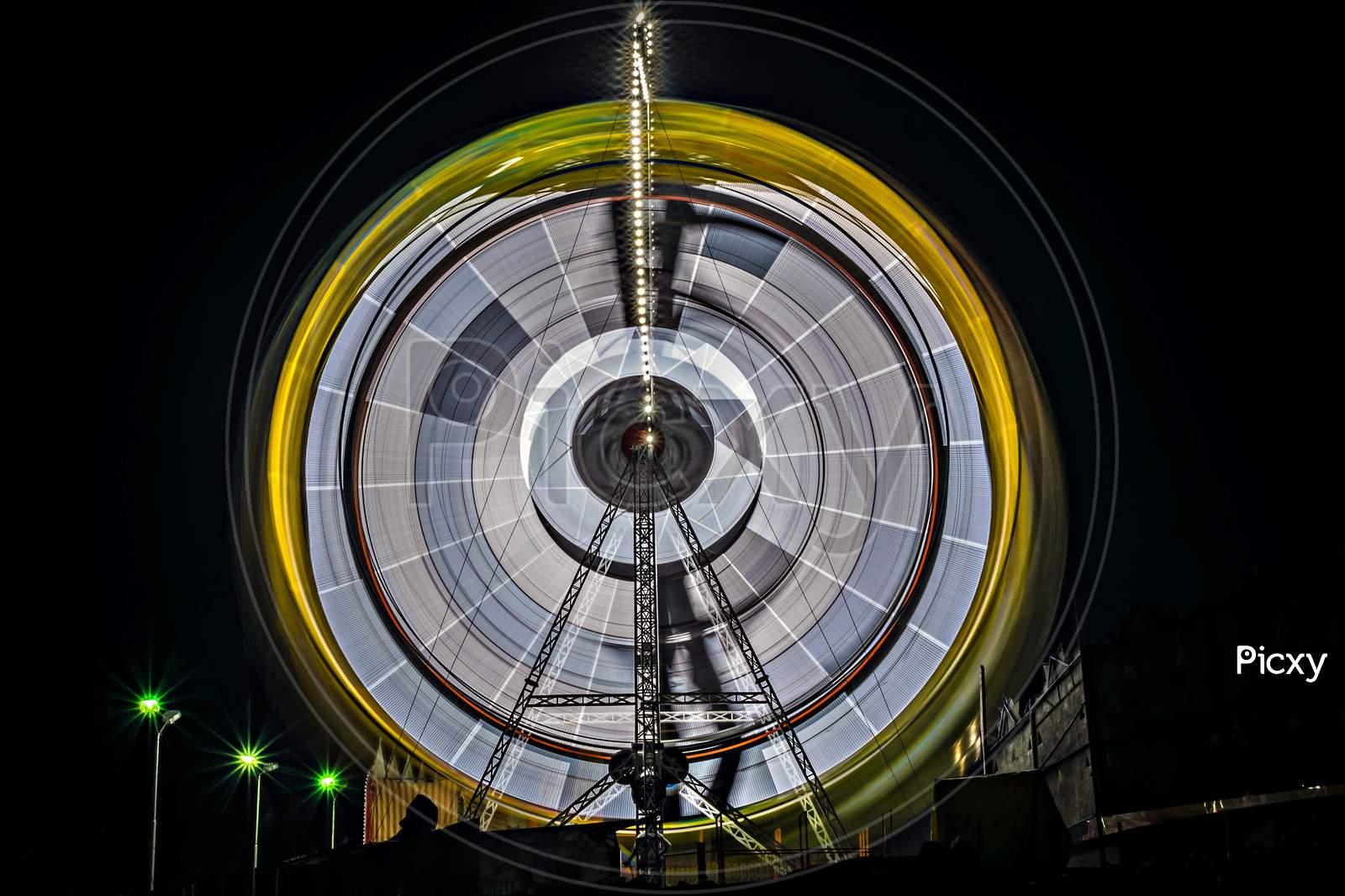 Slow Shutter, Night Image Of A Spinning Giant Wheel In Funfair In Pune.