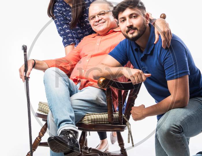 Indian Asian Senior Man With Kids While Sitting On Rocking Chair