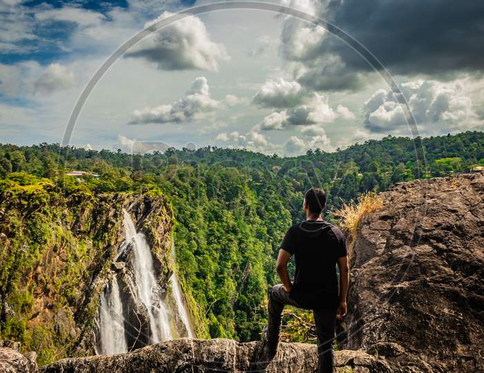 Man Watching The Beautiful Jog Falls Nestled In Western Ghat Forests From Above Flat Angle Shots
