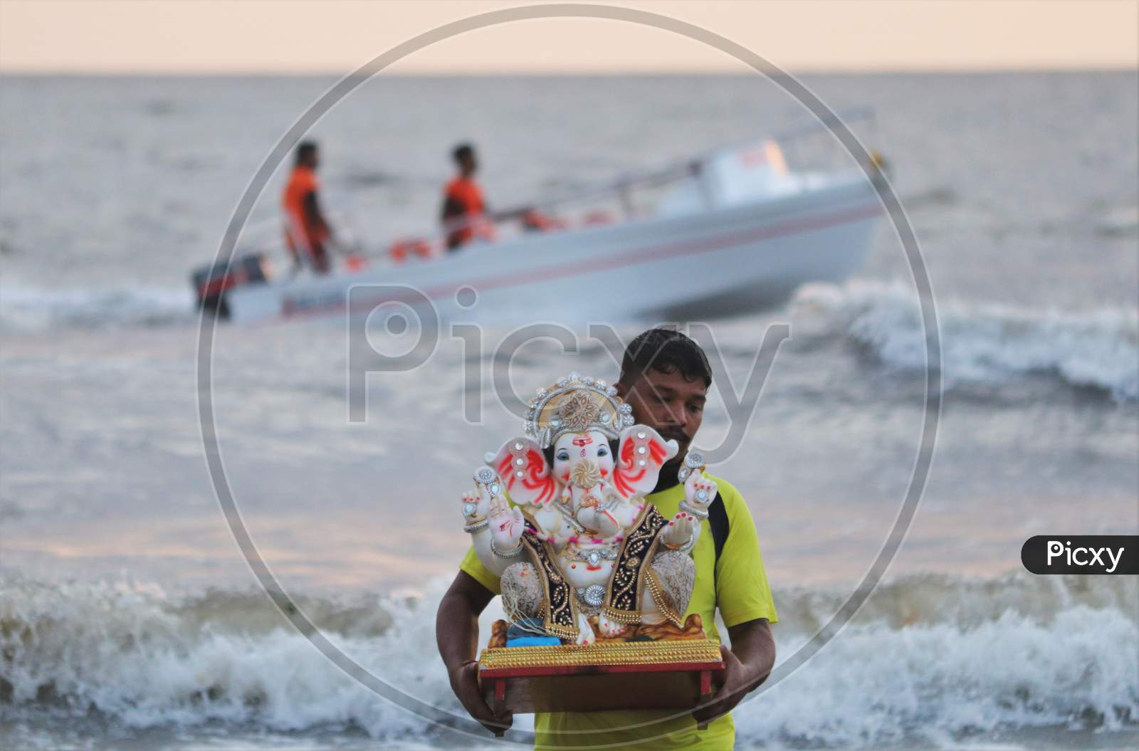 A man carries an idol of the Hindu god Ganesh, the deity of prosperity, to immerse it into the waters of the Arabian sea on the fifth day of the 10-day long Ganesh Chaturthi festival in Mumbai, India on August 26, 2020.