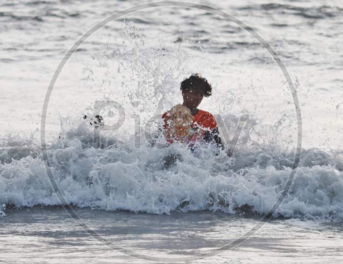 A man immerses an idol of the Hindu god Ganesh, the deity of prosperity, into the waters of the Arabian sea on the fifth day of the 10-day long Ganesh Chaturthi festival in Mumbai, India on August 26, 2020.