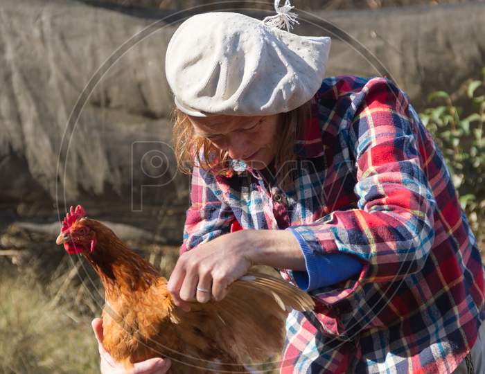 Portrait Of An Argentine Farm Worker Woman With A Hen