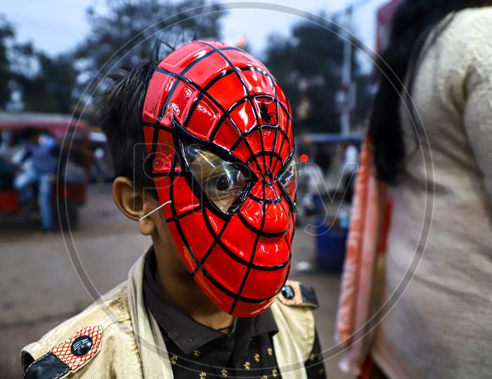 A boy wear spiderman mask at the streets of vrindavan