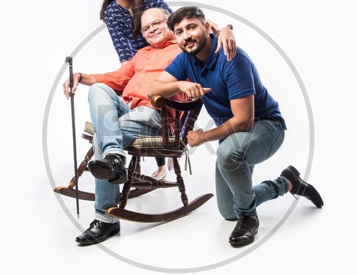 Indian Asian Senior Man With Kids While Sitting On Rocking Chair