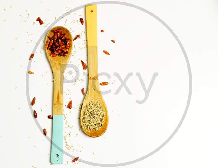 Top View Of Wooden Spoons With Chilli Peppers On A White Background. Gastronomic Concept.