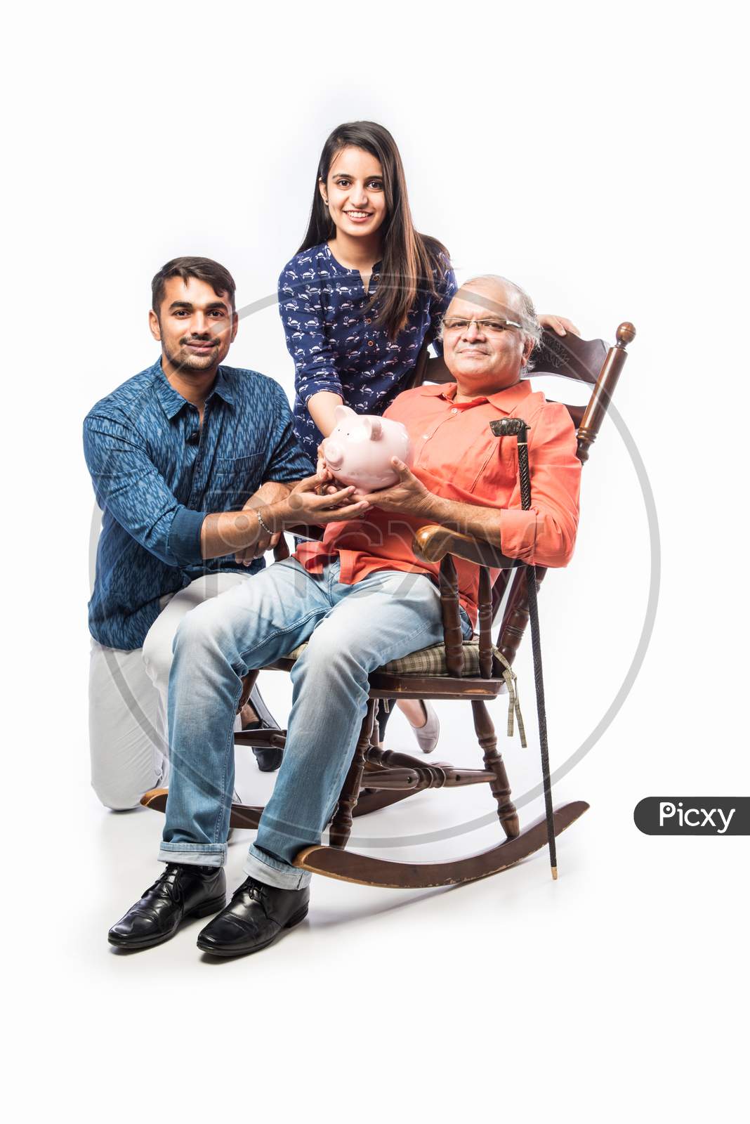 Indian Asian Senior Man With Piggy Bank And Kids While Sitting On Rocking Chair