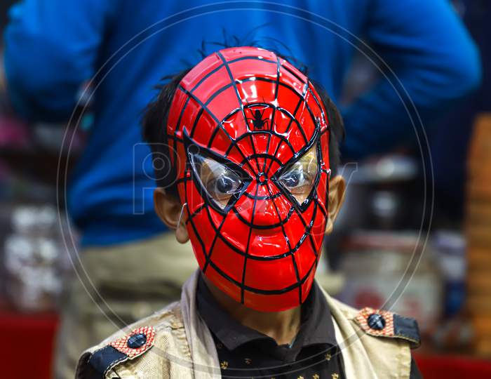 A boy wear spiderman mask at the streets of vrindavan