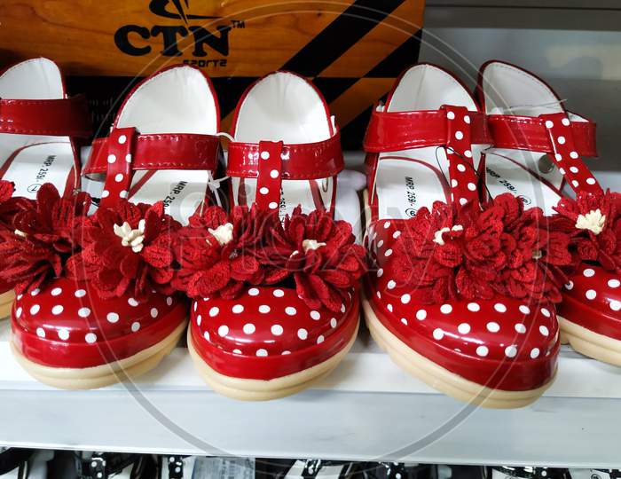 Red Color Girl Baby Shoes In A Shelf For Sale In A Mall. Interior Design Of A Foot Wear Department In Vishal Mall, Laggere