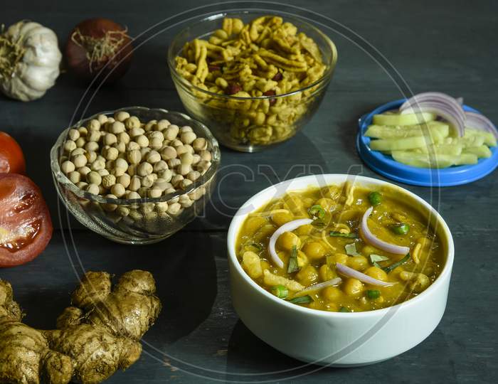 Ghugni, A preparation of Dried peas with Spices,chanachur,Tomatoes,Onions and Green Chilies. It is a famous street food of Eastern India.