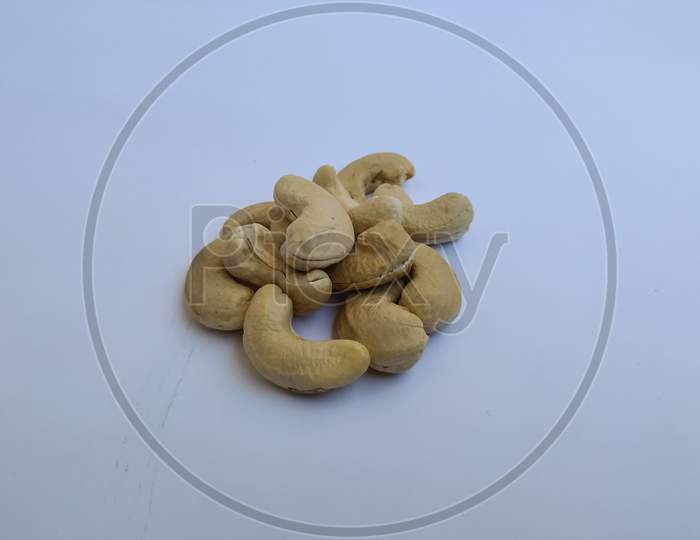 Group Of Cashews In A White Background. Dry Fruits Or Nuts Of Cashew Heap On White Background