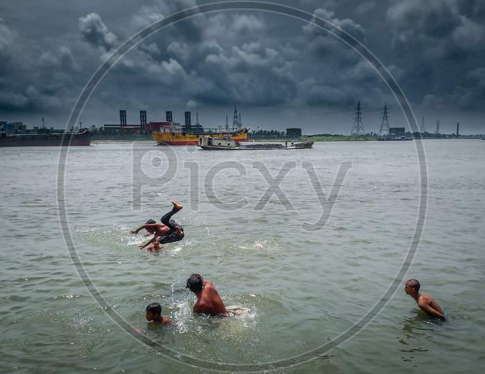 Children Are Enjoying By Jumping In The River Under Beautiful Summer Cloudy Blue Sky . I Captured This Image From Asia, Dhaka, Bangladesh