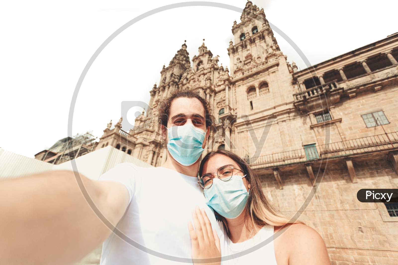 Young Couple Taking A Selfie In A Touristic Place With The Masks On