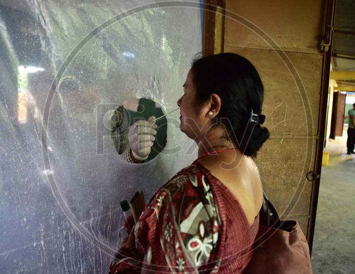 A woman gives a swab sample for Covid-19 test in Nagaon district of Assam on August 26,2020.