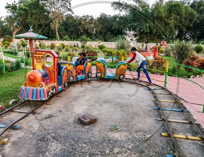 Kids are enjoying a Little toy at a Amusement park