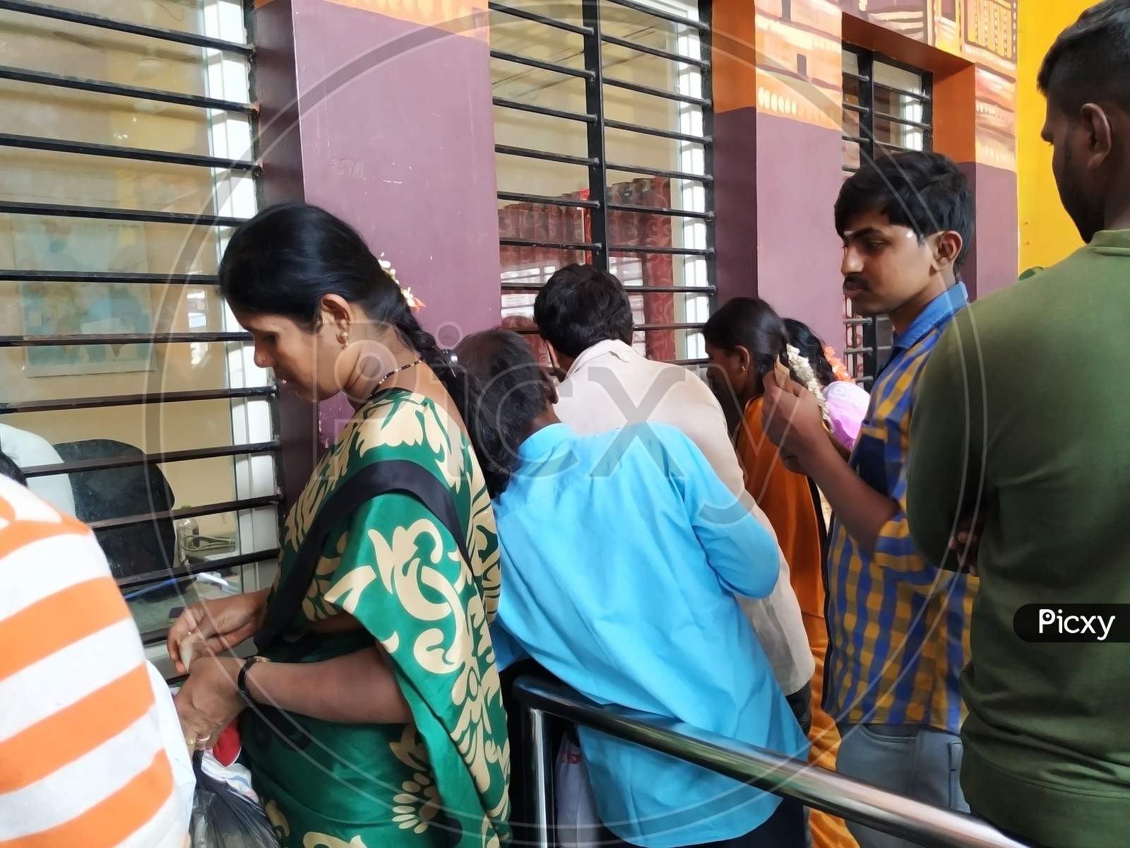 Interior Design Of Pandavapura Railway Station Ticket Counter And People In The Queue To Purchase Ticket