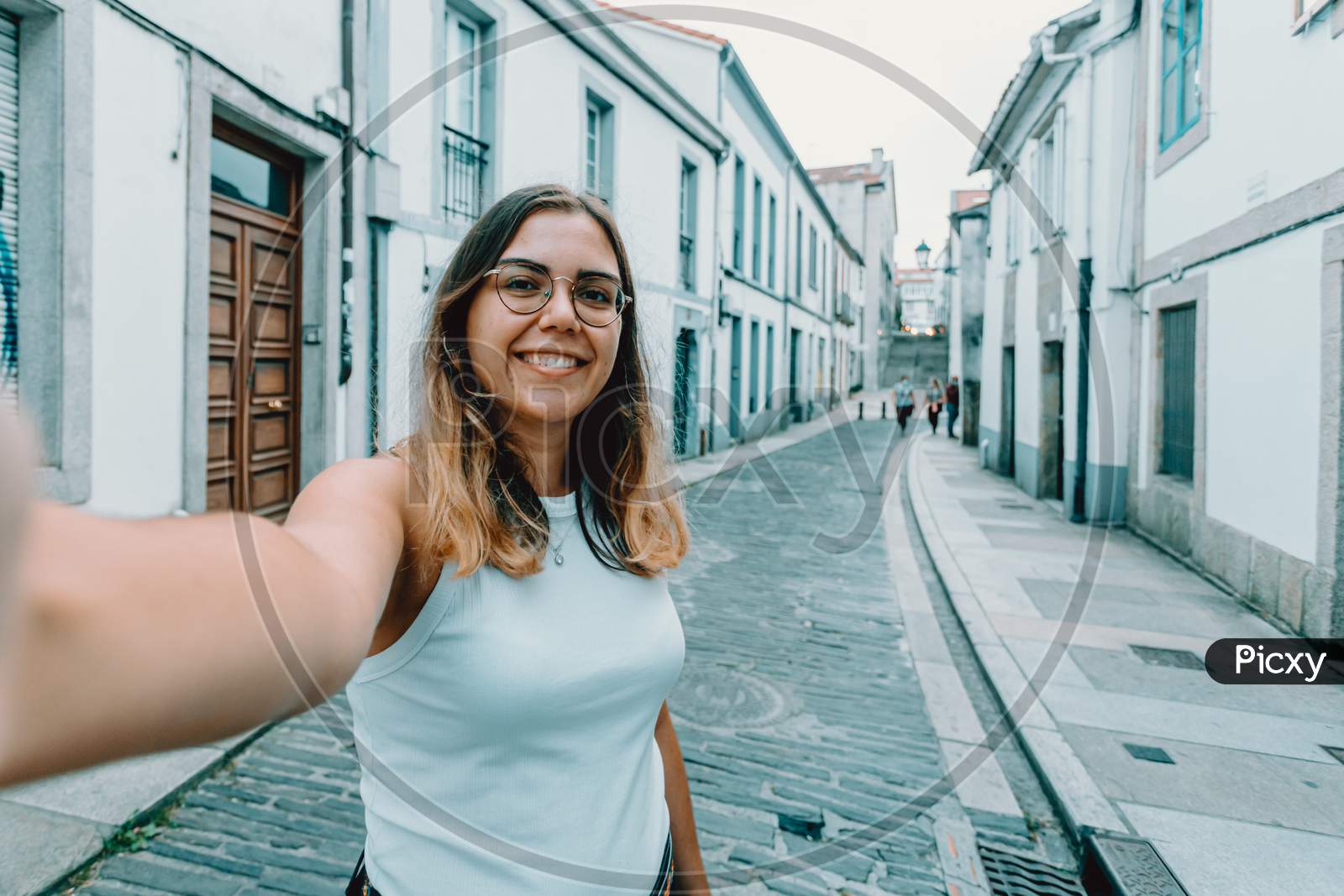 Young Woman With Glasses Taking A Selfie On A Old Spanish Street
