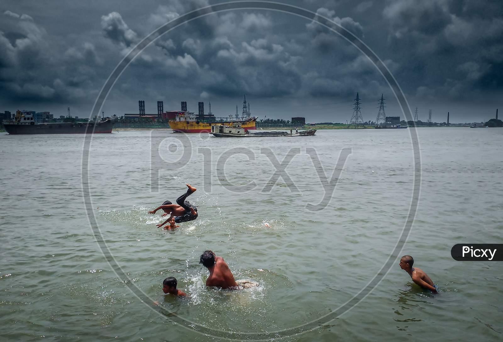 Children Are Enjoying By Jumping In The River Under Beautiful Summer Cloudy Blue Sky . I Captured This Image From Asia, Dhaka, Bangladesh