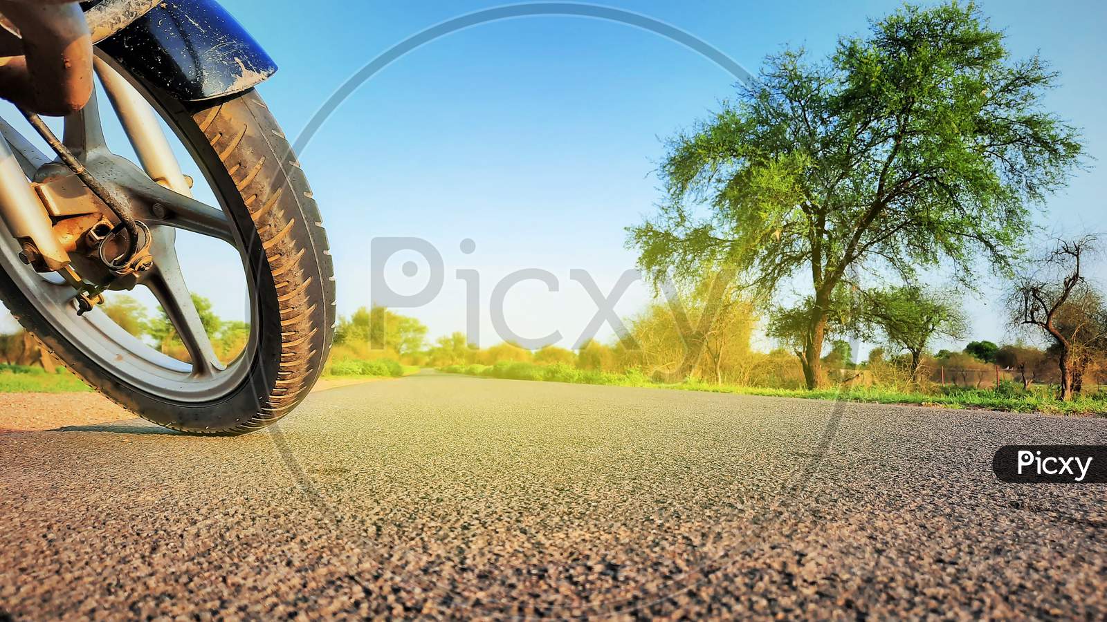 A Motorcycle Standing On Road Front Tyre Closeup