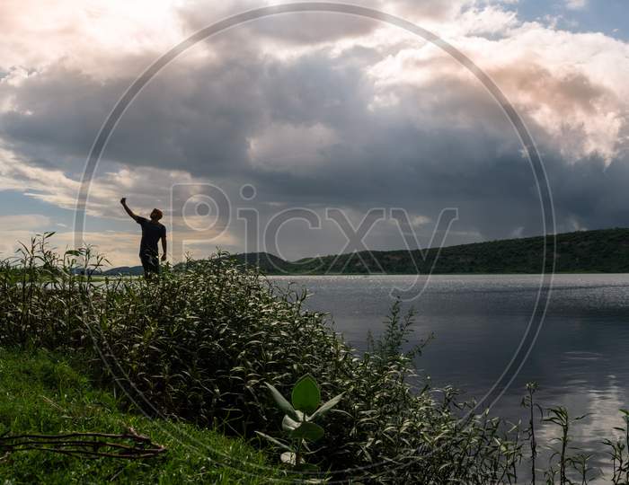 A man taking selfie near Band Baretha dam under the cloudy sky in Bayana Tehsil of Bharatpur district in Rajasthan