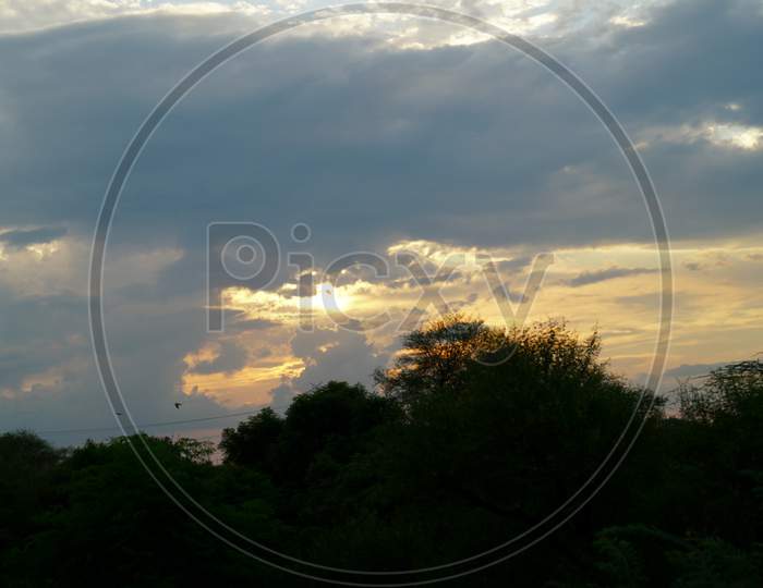 Beautiful Panoramic sunset view with wet cloudy sky.
