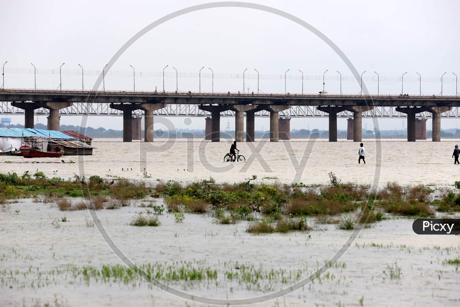 People Cross The Flood Water Of River Ganga In Prayagraj, August 29, 2020.