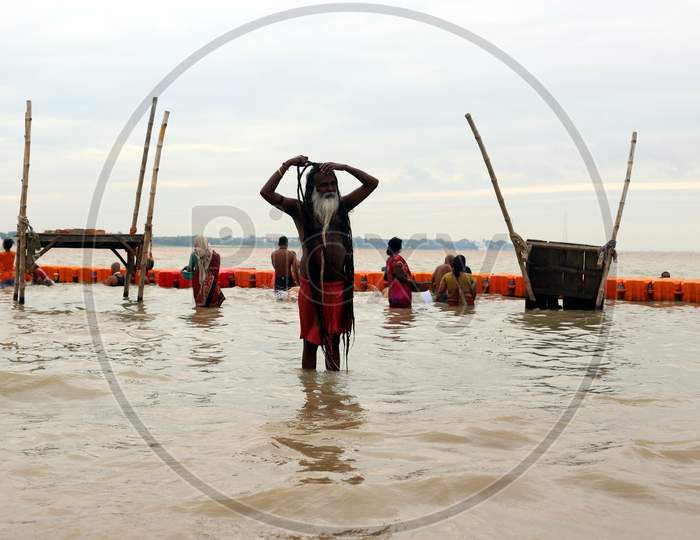 A Sadhu Or Holy Man Returns After Taking A Holy Bath In The Flood Water Of River Ganga In Prayagraj, August 29, 2020.