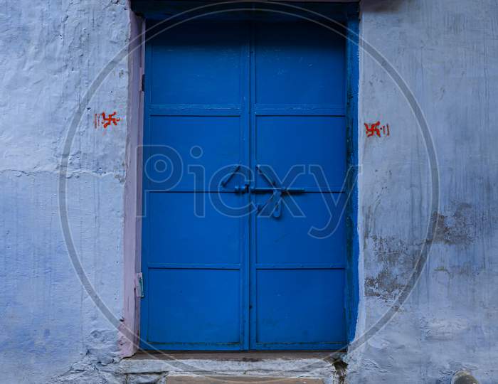 Beautiful old blue gate of iron with white wall