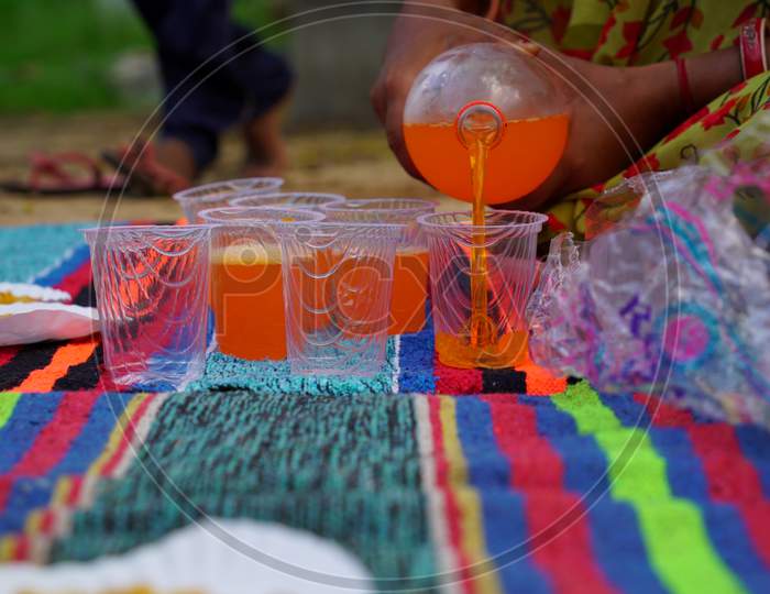 Close up view of Pouring soft drinks in plastic glasses. Cold pressed beverage. Soft drink concept.