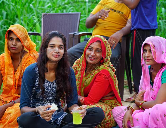 Jodhpur, Jaipur, India- 20 April, 2020; Traditional Indian joint family sitting in a farmland. Enjoying vocational trip. lifestyle concept.