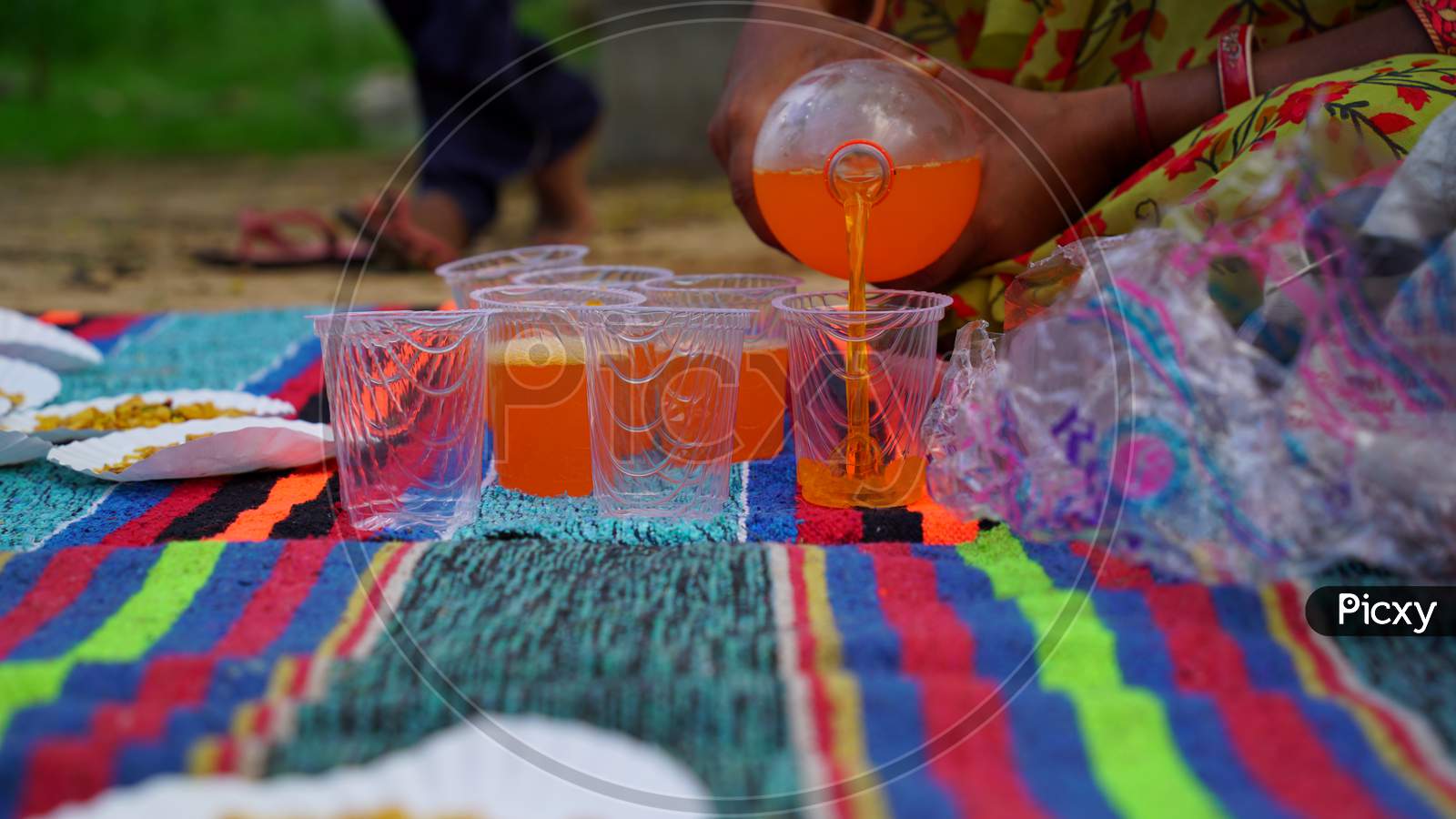 Close up view of Pouring soft drinks in plastic glasses. Cold pressed beverage. Soft drink concept.