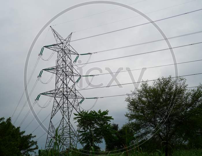 High Power lines view, surrounding by wet rainy clouds. Enchanting climate conditions, beautiful nature sight .