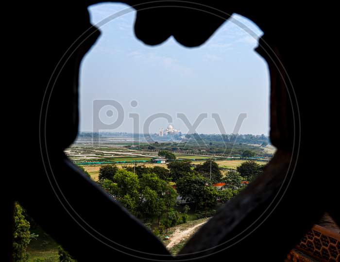 beautiful view of a taj mahal from the window of a red fort,agra
