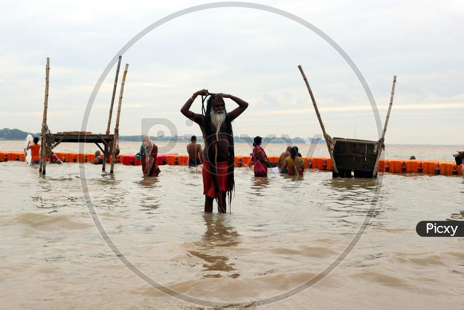 A Sadhu Or Holy Man Returns After Taking A Holy Bath In The Flood Water Of River Ganga In Prayagraj, August 29, 2020.
