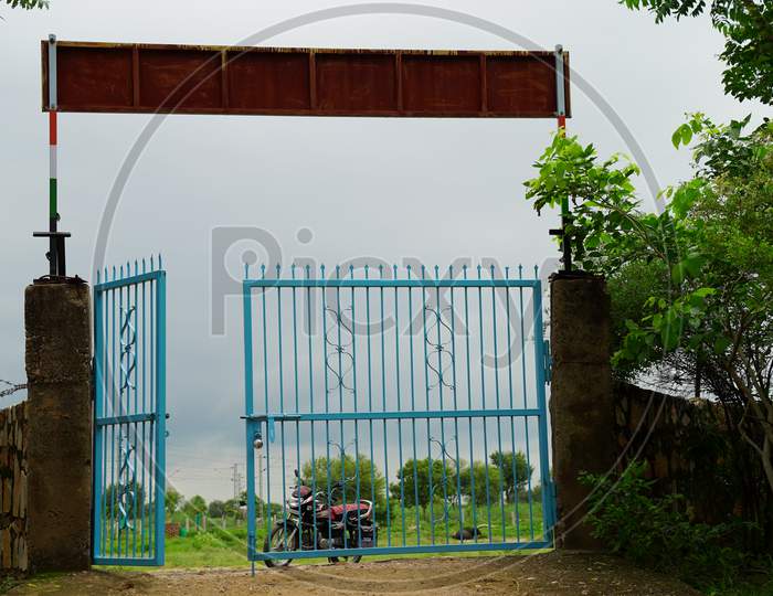 Iron fence gate of School. Empty gate without children.