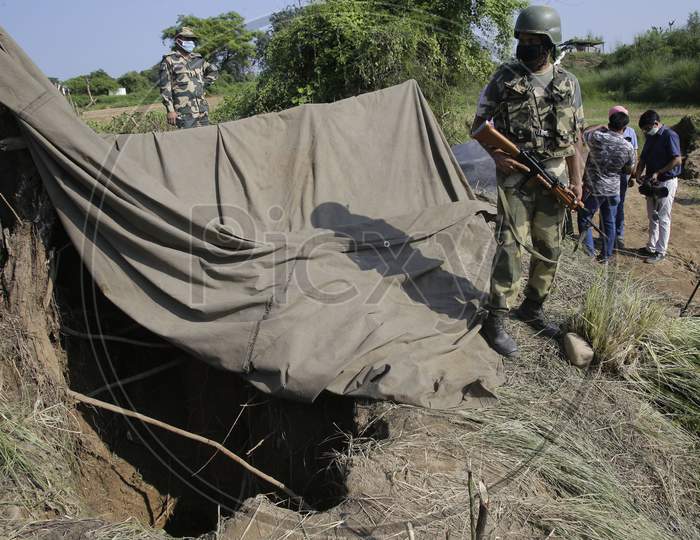 Border Security Force (BSF) personnel stand near a tunnel, originating from Pakistan, beneath the Indo-Pak international border fence, in J&K's Samba district,  Aug. 29, 2020.