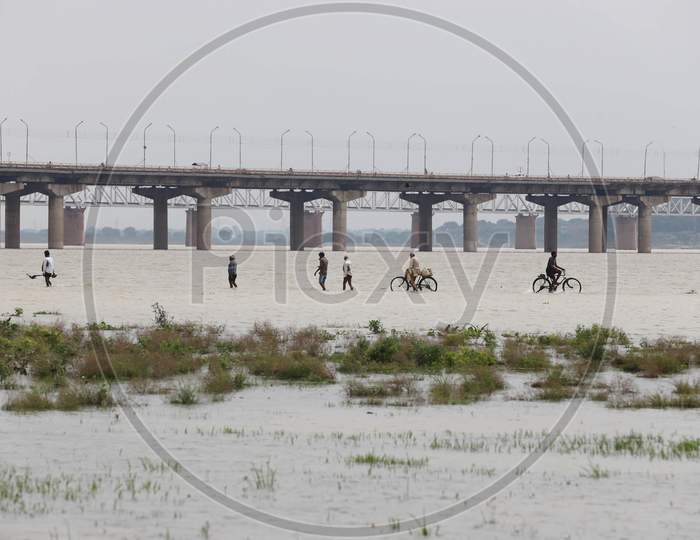People Cross The Flood Water Of River Ganga In Prayagraj, August 29, 2020.