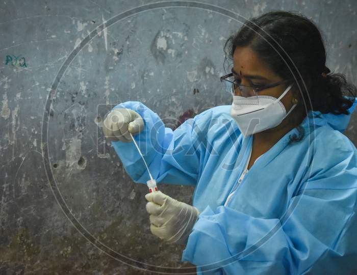 A Health Worker Collects Swab Samples For The Covid-19 Test, At A Makeshift Swab Collection Center, In Vijayawada On August 28, 2020.