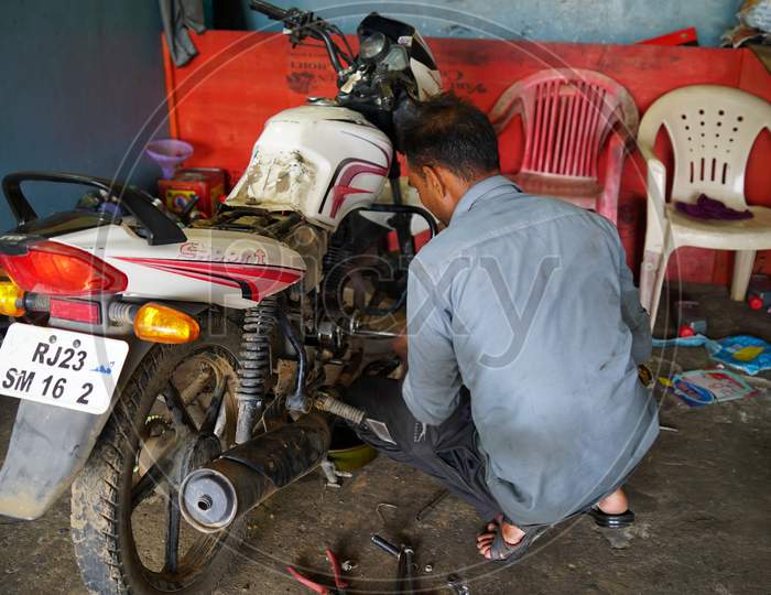 Professional Bike Engineer repairing a bike in a workshop.