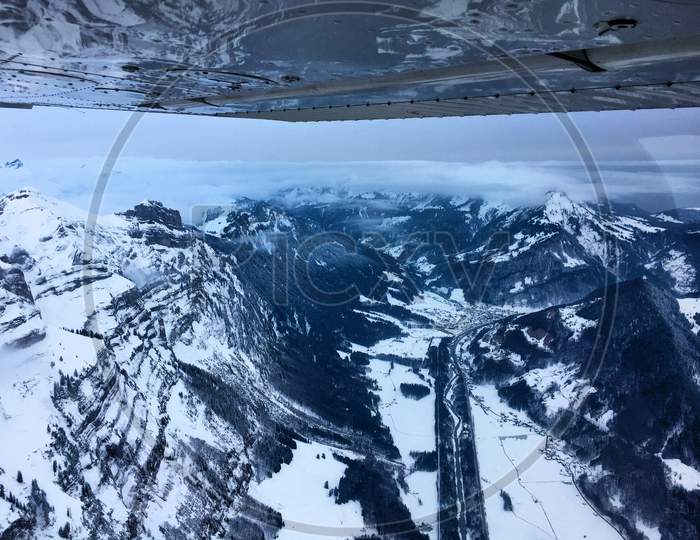 Snow covered mountains in Austria during a flight 10.2.2017with a propeller plane